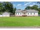 Charming single-story home features white siding, a welcoming front porch, and a spacious lawn at 1593 Bloomfield Rd, Rock Hill, SC 29732