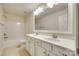 Bright bathroom featuring a double vanity, a large mirror, and a tub with shower at 169 Halifax Dr, Fort Mill, SC 29707