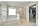 Bathroom featuring a soaking tub next to a glass shower and a peek into the closet at 169 Halifax Dr, Fort Mill, SC 29707