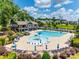 Community pool with ample seating, umbrellas, and a splash fountain, ideal for relaxation and socializing at 169 Halifax Dr, Fort Mill, SC 29707