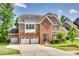 Charming two-story home with a brick and stone facade, complemented by a well-manicured lawn and a three car garage at 169 Halifax Dr, Fort Mill, SC 29707