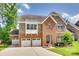 Beautiful brick and stone two-story home with three-car garage and well-manicured lawn at 169 Halifax Dr, Fort Mill, SC 29707