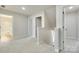 Upstairs hallway with neutral carpet and access to bedrooms and bathrooms at 169 Halifax Dr, Fort Mill, SC 29707