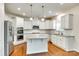 Gourmet kitchen with stainless steel appliances, granite countertops, and white cabinetry at 169 Halifax Dr, Fort Mill, SC 29707