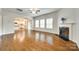 Spacious living room featuring hardwood floors, fireplace, and kitchen view at 169 Halifax Dr, Fort Mill, SC 29707