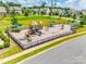 Aerial view of neighborhood playground featuring shaded benches, play structures, and a safe, fenced play area at 169 Halifax Dr, Fort Mill, SC 29707