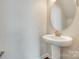 Clean powder room features pedestal sink and decorative mirror at 169 Halifax Dr, Fort Mill, SC 29707