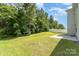 Spacious backyard with a white fence and concrete patio, perfect for outdoor gatherings at 1691 Ashley Lynn Ct, Stanfield, NC 28163