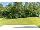 A lush, green backyard with a view of a mature tree line at 1691 Ashley Lynn Ct, Stanfield, NC 28163