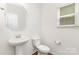 Stylish powder room with a pedestal sink, providing comfort and convenience for guests at 1691 Ashley Lynn Ct, Stanfield, NC 28163