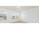 Sunlit bedroom featuring carpeted floors, and two windows offering neighborhood views at 1691 Ashley Lynn Ct, Stanfield, NC 28163