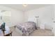 Carpeted bedroom with window and desk with view to neighborhood at 1691 Ashley Lynn Ct, Stanfield, NC 28163