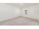 Bright carpeted bedroom with large window allowing ample natural light at 1691 Ashley Lynn Ct, Stanfield, NC 28163