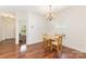 Bright dining room with wood floors and a contemporary chandelier for cozy Gathering meals at 1691 Ashley Lynn Ct, Stanfield, NC 28163
