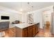 Modern kitchen island with granite countertops and stainless steel appliances overlooks the living room at 1691 Ashley Lynn Ct, Stanfield, NC 28163