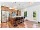 Open kitchen with stainless steel appliances, granite countertops, and an island with barstools at 1691 Ashley Lynn Ct, Stanfield, NC 28163