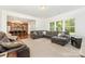 Open-concept living room flowing into a kitchen with modern island seating at 1691 Ashley Lynn Ct, Stanfield, NC 28163