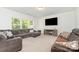 Bright living room with large window, featuring comfortable sofa and entertainment center at 1691 Ashley Lynn Ct, Stanfield, NC 28163