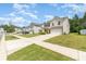Neighborhood street view showcases well-maintained homes and manicured lawns at 1691 Ashley Lynn Ct, Stanfield, NC 28163