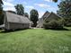 Expansive backyard showcasing the home's exterior and detached garage offering plenty of space for outdoor activities at 179 Delwood Ct, Mount Gilead, NC 27371