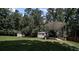 Spacious backyard featuring two storage sheds and a large metal carport for boats or recreational vehicles at 179 Delwood Ct, Mount Gilead, NC 27371