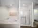 Bright bathroom showcasing a soaking tub, glass-enclosed shower, and modern fixtures at 179 Delwood Ct, Mount Gilead, NC 27371