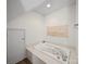Bathroom featuring a jetted soaking tub, white tile surround, and large vanity at 179 Delwood Ct, Mount Gilead, NC 27371