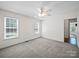 This carpeted bedroom features 2 windows and a ceiling fan for added comfort at 179 Delwood Ct, Mount Gilead, NC 27371