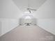 Large carpeted bonus room with good lighting, ceiling fan, and built in shelves at 179 Delwood Ct, Mount Gilead, NC 27371