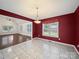 Bright dining room with tile flooring, large windows, and decorative lighting fixture at 179 Delwood Ct, Mount Gilead, NC 27371