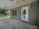 Inviting covered front porch with ceiling fans and a decorative front door at 179 Delwood Ct, Mount Gilead, NC 27371
