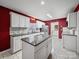 Modern kitchen with white cabinets, granite countertops, and stainless steel appliances at 179 Delwood Ct, Mount Gilead, NC 27371