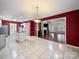 Open concept kitchen with island, tile floors, and adjacent dining and living spaces at 179 Delwood Ct, Mount Gilead, NC 27371