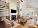 Cozy living room featuring a fireplace, built-in shelving, and hardwood floors at 179 Delwood Ct, Mount Gilead, NC 27371
