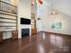 Bright living room with a fireplace, hardwood floors, and built-in bookshelves at 179 Delwood Ct, Mount Gilead, NC 27371