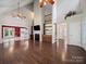 Open living room with hardwood floors, fireplace, and view of the kitchen and entry at 179 Delwood Ct, Mount Gilead, NC 27371
