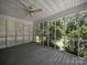 Well-lit screened porch offering an ideal space for relaxation and enjoying the outdoors at 179 Delwood Ct, Mount Gilead, NC 27371
