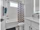 This bathroom features classic white subway tile, a shower-tub combo, and a modern vanity at 1933 W Trade St, Charlotte, NC 28216