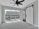 Bedroom with sliding barn door, fan, and sliding glass door to an outdoor patio at 1933 W Trade St, Charlotte, NC 28216