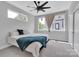 Well-lit bedroom with large windows, neutral decor, and light gray carpet at 1933 W Trade St, Charlotte, NC 28216