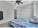 Bright bedroom with sliding door closet, white trim and ceiling fan at 1933 W Trade St, Charlotte, NC 28216