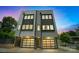 This modern home offers a sleek design with a two-car garage, clean lines, and ample window light at 1933 W Trade St, Charlotte, NC 28216