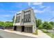 This modern home showcases its exterior with a two-car garage and well-manicured sidewalk at 1933 W Trade St, Charlotte, NC 28216
