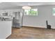 Kitchen with stainless steel appliances, modern white cabinets, and wood flooring at 1933 W Trade St, Charlotte, NC 28216