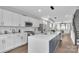 Bright kitchen features white cabinets, stainless appliances, and a large center island at 1933 W Trade St, Charlotte, NC 28216