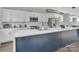 Modern kitchen features white cabinets, a large center island, and stainless appliances at 1933 W Trade St, Charlotte, NC 28216