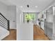 Kitchen with white cabinets, stainless steel appliances, a large island, and hardwood floors at 1933 W Trade St, Charlotte, NC 28216