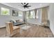 This living room features beautiful hardwood floors, a modern fan, and a comfortable couch at 1933 W Trade St, Charlotte, NC 28216