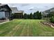 Expansive backyard with a neatly mowed lawn, garden beds, privacy fence and evergreens at 195 Willow Valley Dr, Mooresville, NC 28115