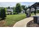 Serene backyard featuring a grill, manicured lawn, a black fence and an outdoor living space at 195 Willow Valley Dr, Mooresville, NC 28115